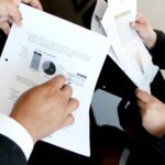 person holding document papers