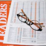 black framed eyeglasses on white and orange paper