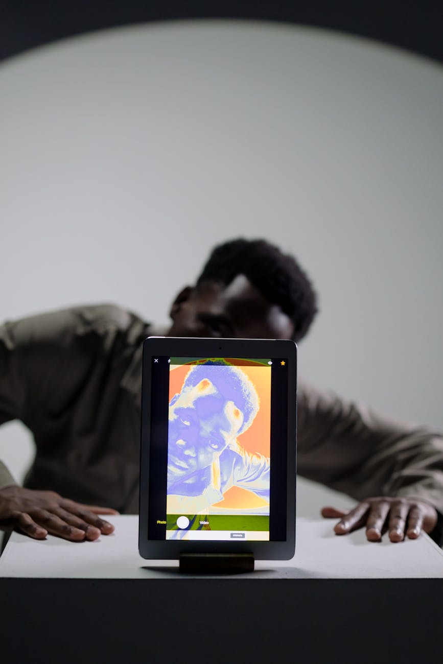 behind the scene picture of a man using tablet