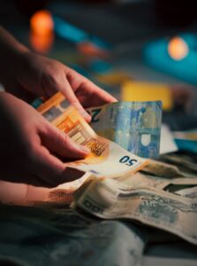 counting euro banknotes in dim lighting