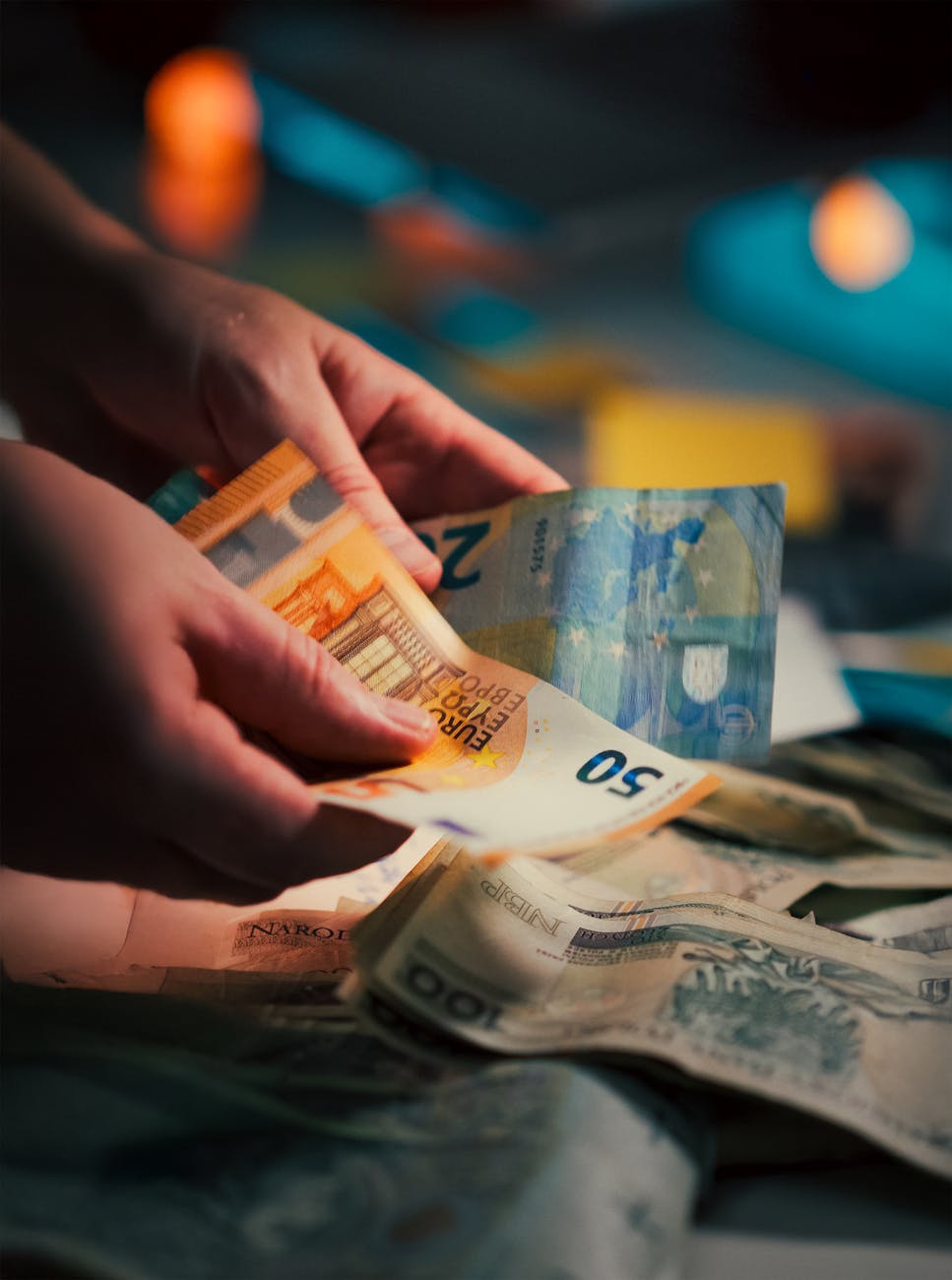 counting euro banknotes in dim lighting