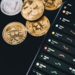 mobile phone beside bitcoins