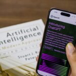 close up of a person holding a smartphone displaying chatgpt