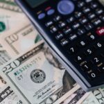 calculator on pile of paper banknotes
