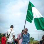 woman with flag on street protest