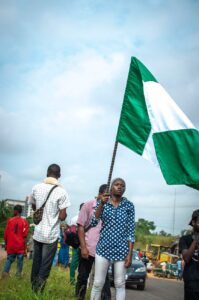 woman with flag on street protest