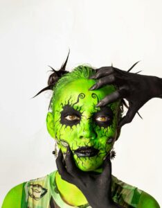 vibrant green face paint with black hands