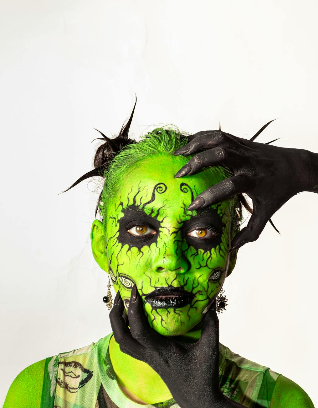 vibrant green face paint with black hands
