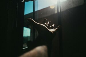 photo of a person reaching out his hand