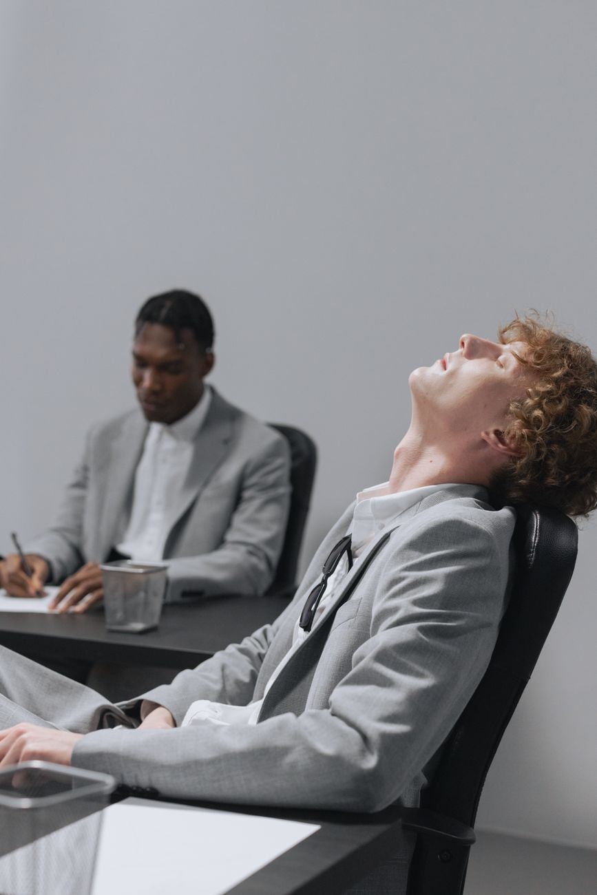 man in gray suit taking a rest while seated