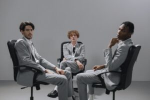 men sitting on the chair while looking with a serious face