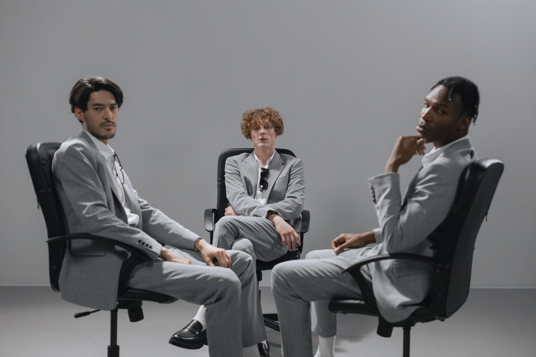 men sitting on the chair while looking with a serious face