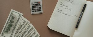 top view photo of notebook near money