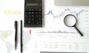 calculator and magnifying glass on survey sheets