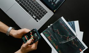 hands holding a smartphone with data on screen