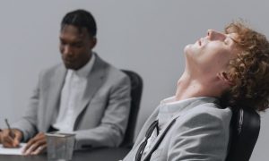 man in gray suit taking a rest while seated