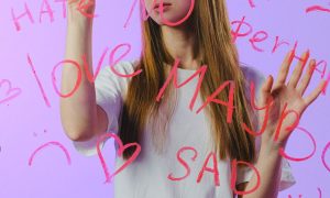 teenage girl touching glass with words
